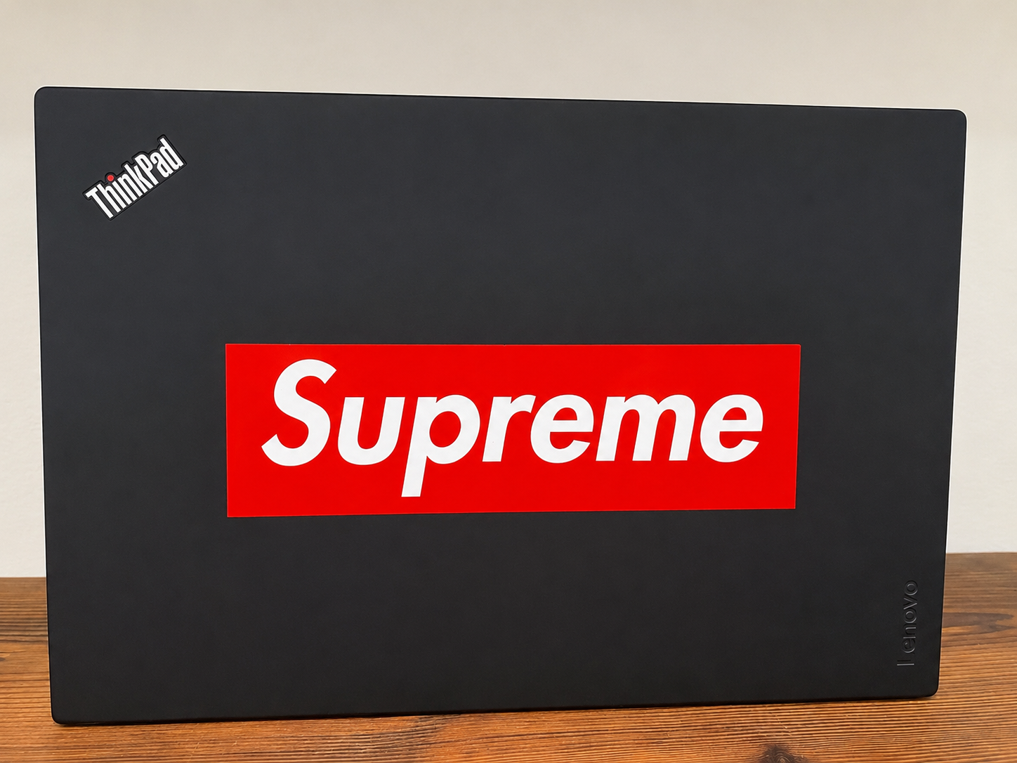 A ThinkPad lid with stickers before the Linux rebuild.