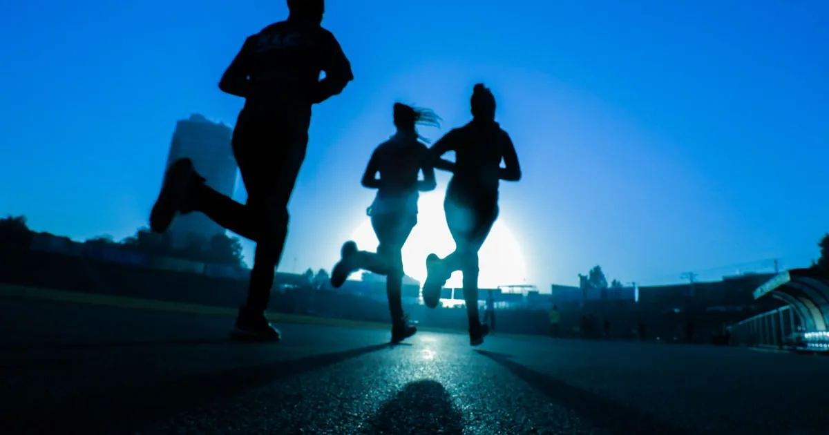 Runner mid-stride outdoors — aerobic exercise lowers blood glucose via insulin-independent GLUT4 translocation